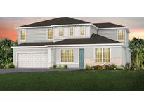 Beautiful two-story home with a blue front door, lush lawn, and a two-car garage at 5688 Flame Vine Way, St Cloud, FL 34771