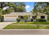 Charming single-story home featuring a well-maintained front yard and attached garage at 575 Lake Mccoy Dr, Apopka, FL 32712