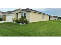 Beautiful single-story home with a two-car garage and well-maintained lawn, perfect for a starter Gathering at 577 Talisi Loop, St Cloud, FL 34771