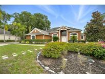 Charming single-Gathering home featuring a lush garden, manicured lawn, and inviting curb appeal at 6839 Hidden Glade Pl, Sanford, FL 32771