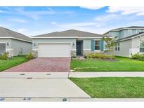 Charming single-story home featuring a brick driveway, well-kept lawn, and inviting curb appeal at 5724 Camilla St, St Cloud, FL 34771