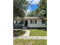Charming single-story home with a covered porch and well-maintained front yard, creating inviting curb appeal at 2075 Dixie Ave, Sanford, FL 32771