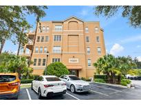 A well-maintained condo building featuring balconies, landscaping, and parking spots for residents at 7500 Toscana Blvd # 331, Orlando, FL 32819