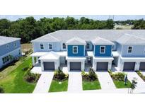 Beautifully landscaped townhomes with attached garages, offering modern living and curb appeal at 7858 Spectrum Dr, Reunion, FL 34747