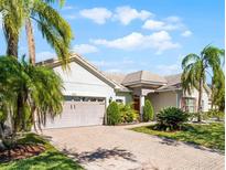 Charming single-story home with paver driveway, mature landscaping, and a two-car garage at 3643 Weatherfield Dr, Kissimmee, FL 34746