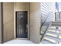 View of the unit's front door with stairs, painted in neutral colors for a modern aesthetic at 408 Summit Ridge Pl # 210, Longwood, FL 32779