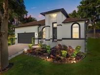 Stunning single-story home with a well-maintained landscape and a two-car garage at 908 Hilly Bend Dr, Apopka, FL 32712