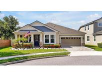 Charming single-story home with landscaped front yard, brick driveway, and an inviting entrance at 14903 Ellingsworth Ln, Winter Garden, FL 34787