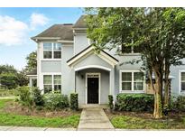 Charming two-story townhouse with a well-maintained lawn, inviting front entrance, and lush landscaping at 3478 Westchester Square Blvd # 204, Orlando, FL 32835