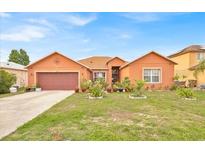 Charming single-Gathering home with a well-manicured lawn and mature landscaping, creating inviting curb appeal at 675 Elbridge Dr, Kissimmee, FL 34758
