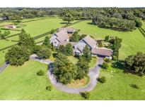 Stunning aerial view of the estate with manicured lawns and a circular driveway leading to the luxurious home at 10621 Sw 11Th Ter, Ocala, FL 34476