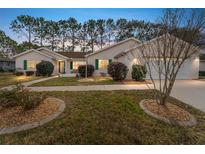 Charming single-story home with landscaped front yard, green shutters and a well-manicured lawn at 8447 Se 137Th Loop, Summerfield, FL 34491