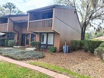 Exterior view of a brown two-story townhome with a balcony at 19728 Sw 83Rd Place Rd # A-1, Dunnellon, FL 34432