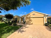 Inviting single-story home showcasing a well-manicured lawn, landscape, and a charming color palette at 16026 Sw 14Th Avenue Rd, Ocala, FL 34473