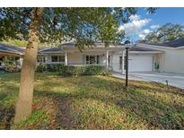 Charming single-story home with a covered porch and manicured front yard at 8655 Sw 98Th Street Rd # G, Ocala, FL 34481