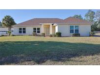 Single-story house with brown roof and a well-maintained lawn at 352 Marion Oaks Ln, Ocala, FL 34473