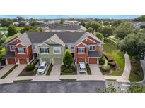 Beautiful townhome exteriors showcase attached garages, vibrant landscaping, and colorful facades at 4230 Sw 50Th Cir, Ocala, FL 34474