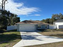 Newly constructed home with a white vinyl fence and a two-car garage at 1696 Sw 144Th Ct, Ocala, FL 34481