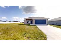 New single-story house with blue garage door and grassy yard at 5348 Se 91St Pl, Ocala, FL 34480