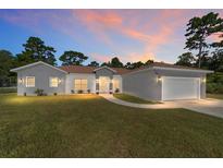 Charming single-story home featuring a well-manicured lawn and attached two-car garage at 14550 Sw 61St Ct, Ocala, FL 34473