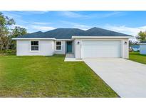 Newly constructed one-story home with a two-car garage and landscaped lawn at 7128 Sw 134Th St, Ocala, FL 34473