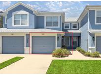 Charming townhome showcasing a well-maintained exterior with a garage and landscaping at 4560 Sw 52Nd Cir # 101, Ocala, FL 34474