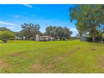 Ranch-style home on large lot with mature trees and detached barn at 1000 Se 155Th St, Summerfield, FL 34491