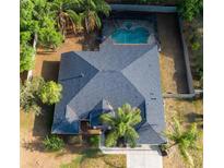 A bird's eye view of a home with a screened-in pool and lush landscaping offering a private backyard oasis at 5650 Se 34Th St, Ocala, FL 34480