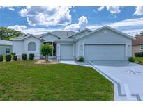 Charming single-story home with a well-manicured lawn, complemented by a two-car garage and a beautifully designed driveway at 15268 Sw 14Th Avenue Rd, Ocala, FL 34473
