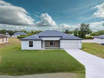 Charming single-story home featuring a well-manicured lawn and a neutral color palette at 10107 Sw 41St Ave, Ocala, FL 34476