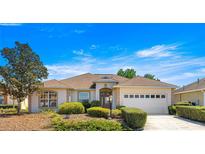 Charming single-story home with manicured landscaping and attached two car garage at 9882 Sw 89Th Lane Rd, Ocala, FL 34481