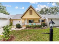 Charming single-story home featuring a cute front porch with an A-frame roof and lovely landscaping at 9357 Sw 82Nd Ter # B, Ocala, FL 34481