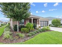 Charming single story home with manicured lawn and colorful, mature landscaping at 7709 Sw 86Th Ct, Ocala, FL 34481