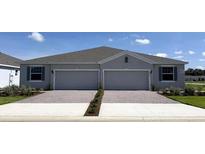 Charming single-story duplex featuring a paved driveway, two-car garages, and well-manicured landscaping at 4743 Nw 39Th Street Rd, Ocala, FL 34482