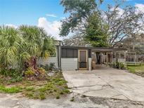 Charming single-story home featuring a carport, well-maintained landscaping, and a cozy entrance at 34828 1St Ave, Leesburg, FL 34788