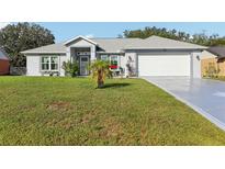 Single-story home with attached garage and well-manicured lawn at 33629 Dolores Ct, Leesburg, FL 34788