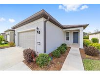 Single-story home with attached garage, landscaping, and walkway at 6014 Sw 93Rd Cir, Ocala, FL 34481