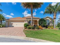 One-story home with a two-car garage and landscaped front yard at 1135 Burke Ct, The Villages, FL 32162