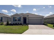 Charming single-story home with a two car garage, stone accents, and well-manicured front lawn at 4111 Nw 48Th Terrace Rd, Ocala, FL 34482