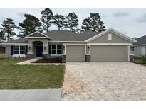 Charming single-story home with a two-car garage and inviting front lawn at 7143 Sw 179Th Court Rd, Dunnellon, FL 34432