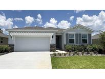 Charming single-story home with a two-car garage, landscaped yard, and a well-manicured lawn at 9313 Sw 60Th Court Rd, Ocala, FL 34476