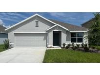 Charming single-story home with a two-car garage and manicured lawn at 8457 Las Palmas Way, Wildwood, FL 34785