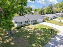 Charming single-story home featuring a spacious front yard and a long driveway leading to an attached garage at 4360 Se 58Th Pl, Ocala, FL 34480