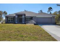 Charming one-story home featuring a well-manicured lawn and a two-car garage at 2536 Sw 165Th Street Rd, Ocala, FL 34473