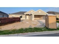 Exterior view of home with gray paint, showing construction debris in the yard at 8357 Sw 58Th Ave, Ocala, FL 34476