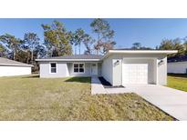 Newly constructed home with a one-car garage and a well-manicured lawn at 232 Locust Pass, Ocala, FL 34472