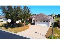 Beautiful home featuring a brick paved driveway, well manicured lawn and mature landscaping at 16331 Sw 12Th Ter, Ocala, FL 34473