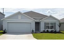 Charming single-story home featuring a two-car garage, manicured lawn, and welcoming entrance at 8838 Sw 48Th Ave, Ocala, FL 34476