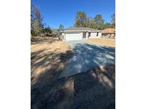 Newly constructed home with a driveway and landscaping at 15923 Sw 41St Street Rd, Ocala, FL 34481