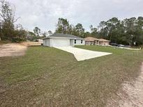 Charming single-story home featuring a well-manicured lawn and a two-car garage at 15923 Sw 41St Street Rd, Ocala, FL 34481